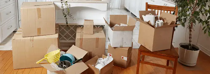 Packed moving boxes and household items in a kitchen before move-out or move-in cleaning, Charlotte, NC.